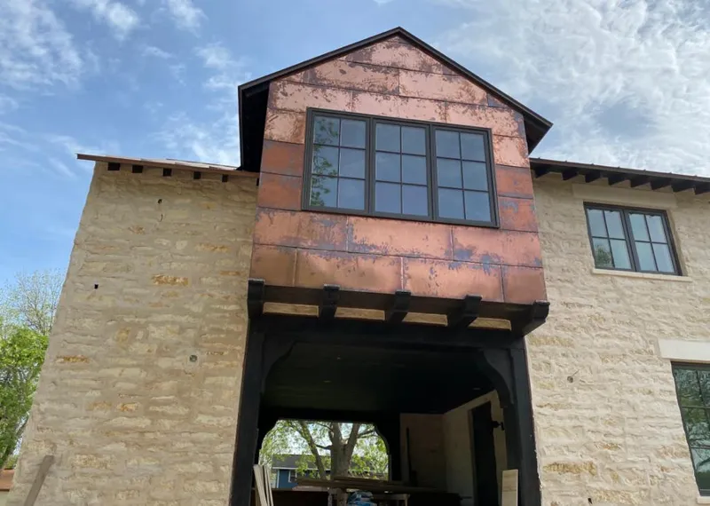 Copper metal panel facade on a stone building for Roof Repair in Lee's Summit