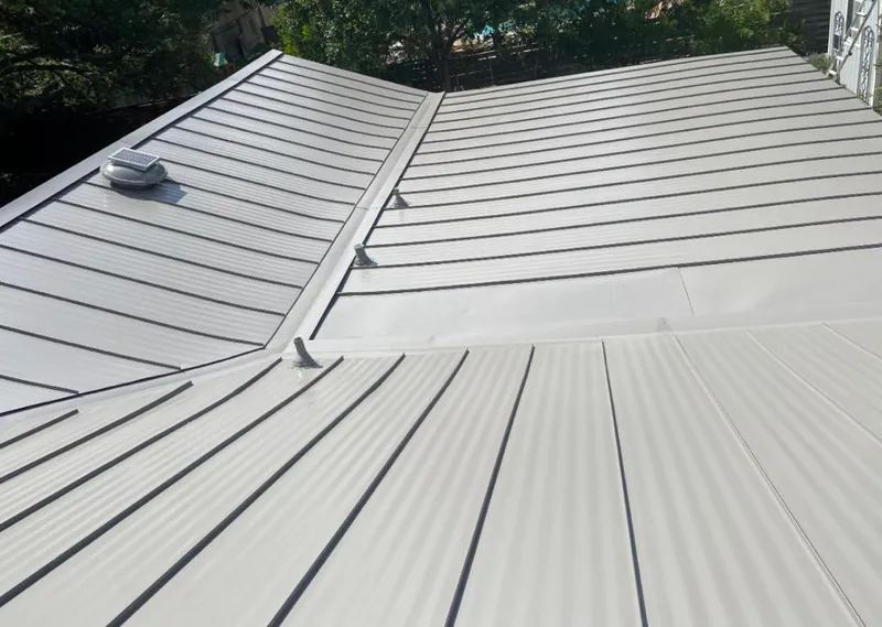 Solar attic fan installed on a metal roof for Roof Ventilation in Lee's Summit